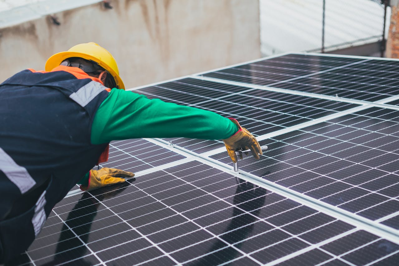 services-03 Technician installing solar panels on a rooftop for sustainable energy solutions.